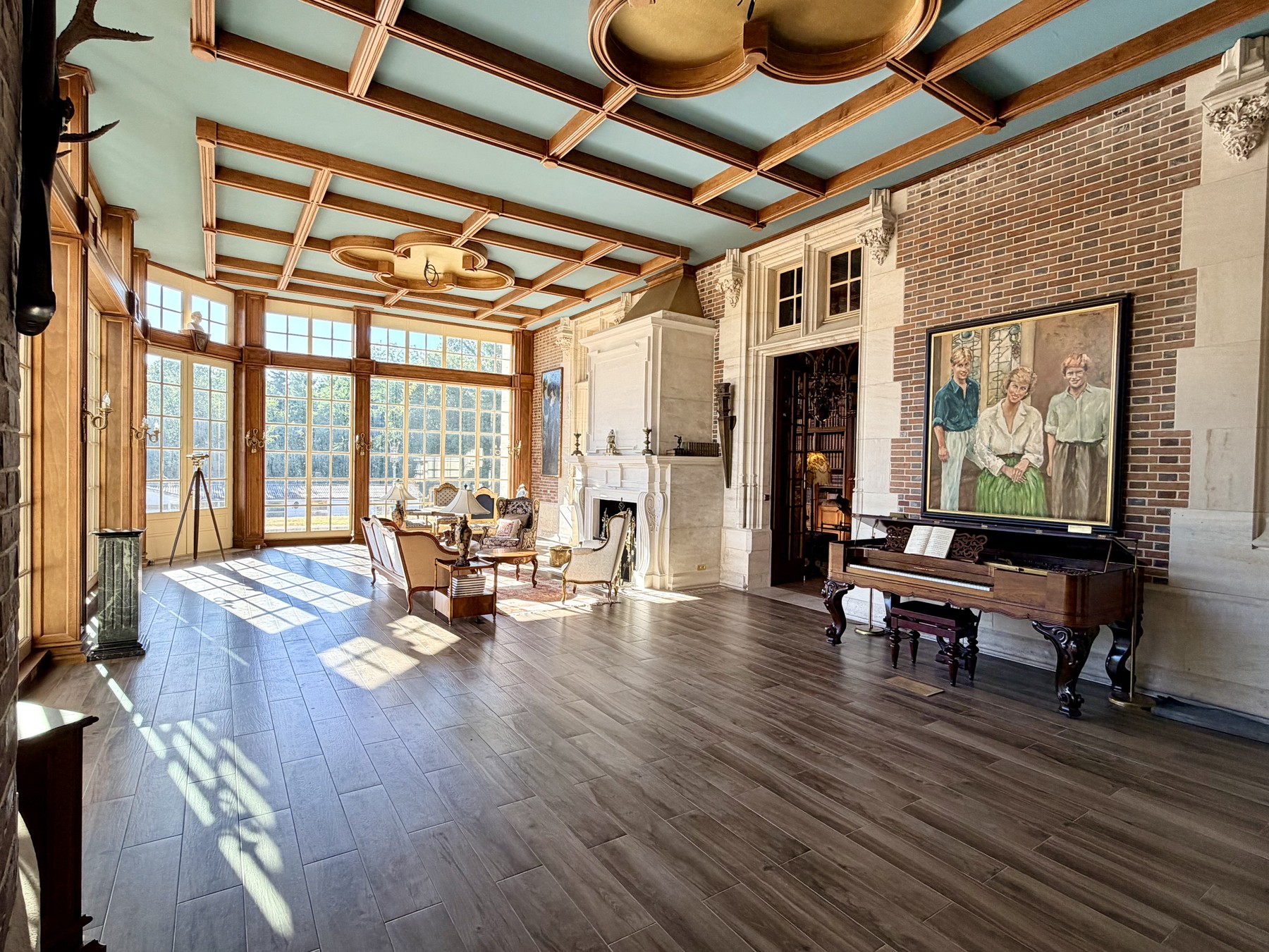 The Orangerie, a bright sunlit room with a grand piano, set for an evening celebration
